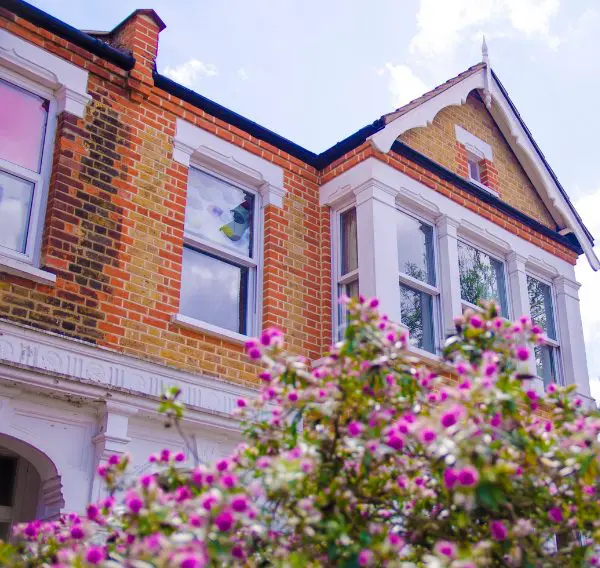 Attractive Scottish house with purple flowers in the garden, symbolising residential property sales in Scotland