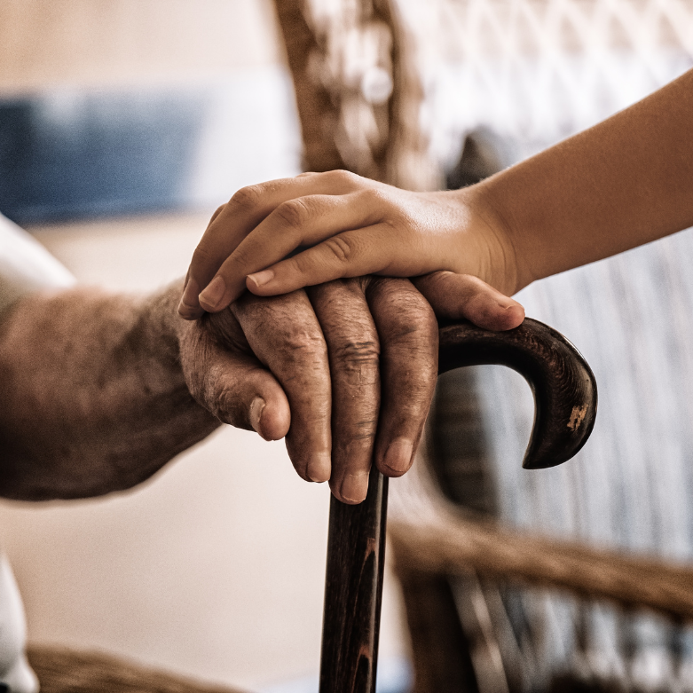 Younger hand supporting older hand — symbolising financial guardianship and caring for adults with incapacity in Scotland