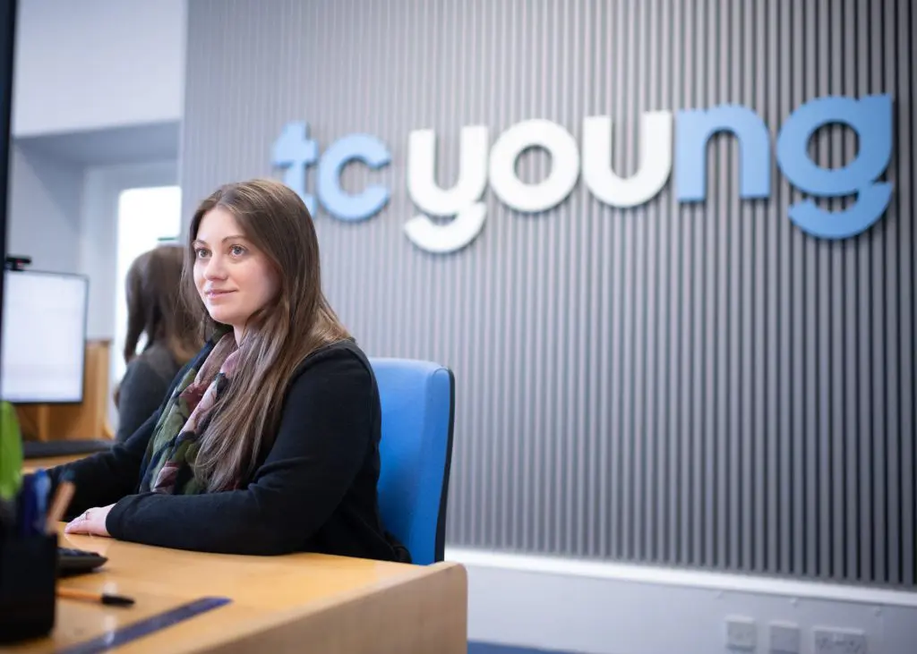 TC Young employee at reception, representing approachable defamation legal support