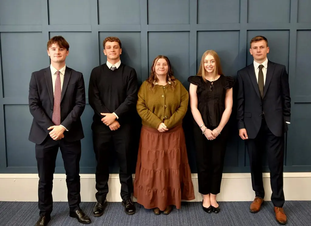 Five new trainee solicitors standing together at TC Young Solicitors in Scotland
