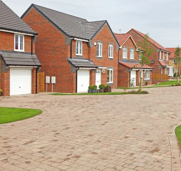 Modern red brick detached homes in a new build housing estate, representing residential property in Scotland