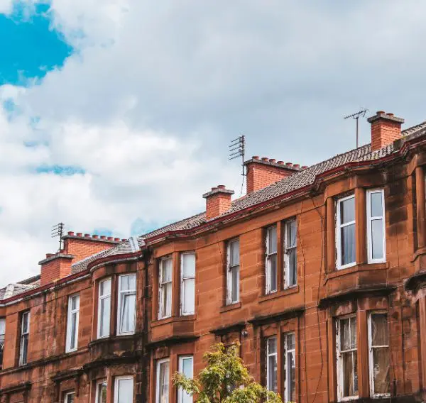 Red sandstone tenement block in Scotland, representing private rented sector properties