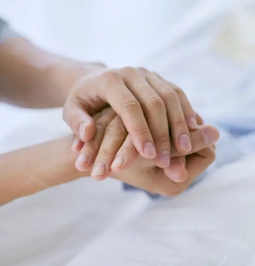 Relative holding the hand of an adult lacking capacity, symbolising guardianship and support in Scotland