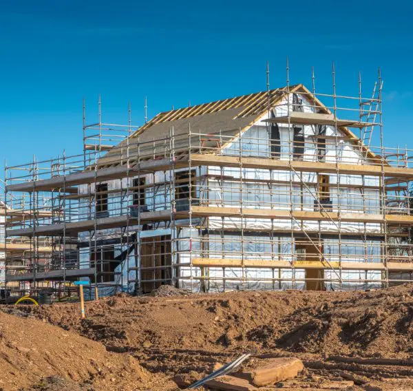 House under construction at golden brick stage showing foundations and initial brickwork for VAT zero-rated land purchase
