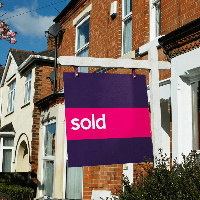 Purple “sold” sign in front of a traditional Scottish terraced house, representing properties for sale and estate agency services