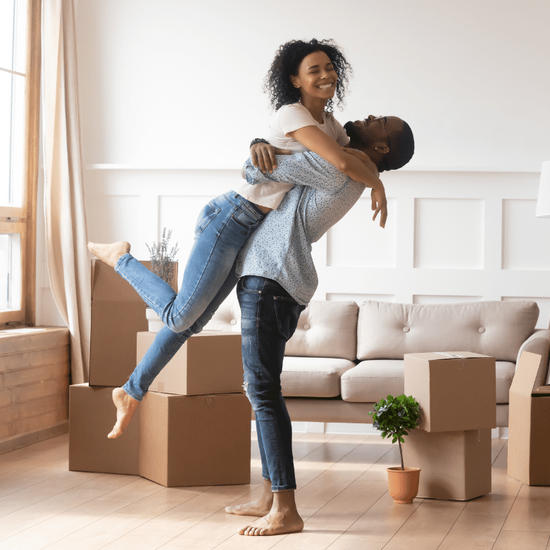 Young couple unpacking boxes in a new home, symbolising cohabitation agreements in Scotland