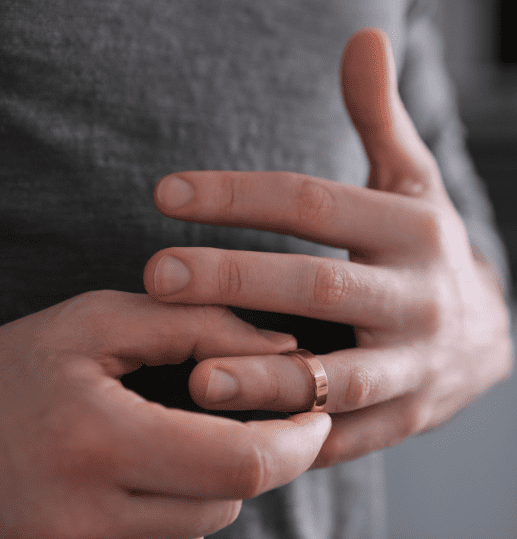 Woman removing her wedding ring – symbolising separation and divorce in Edinburgh
