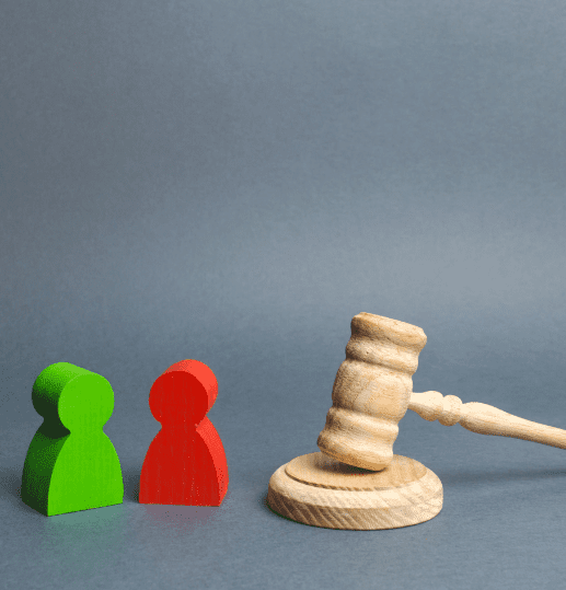 Red and green figure next to a gavel representing contract dispute resolution in Scotland