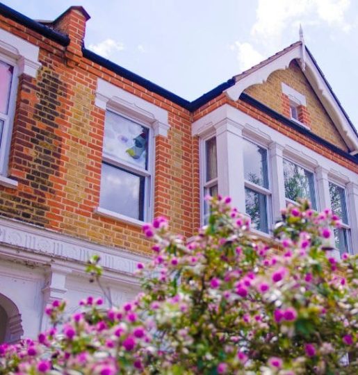 Attractive Scottish house with purple flowers in the garden, symbolising residential property sales in Scotland