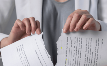 Contract torn in half representing breach of contract in Scotland