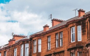 Red sandstone tenement block in Scotland, representing private rented sector properties