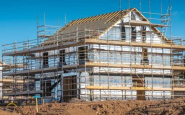 House under construction at golden brick stage showing foundations and initial brickwork for VAT zero-rated land purchase