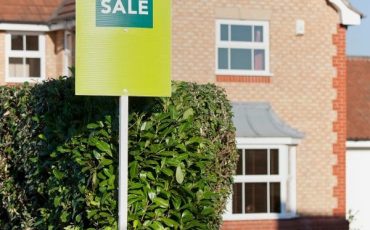 Modern home in Scotland with a For Sale sign outside