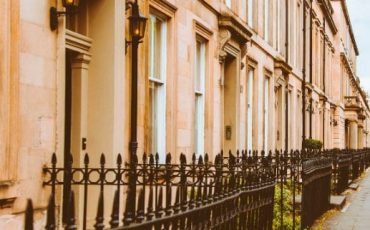 Traditional Scottish street with sandstone tenements, representing rental properties in Scotland